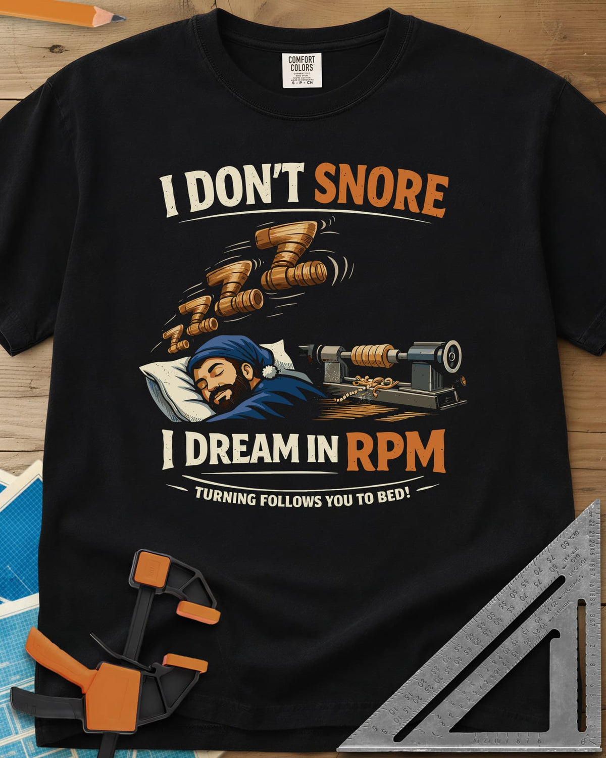 Dream in RPM heavyweight tee in Black, a sleeping woodturner in a nightcap, wooden Zs and a lathe