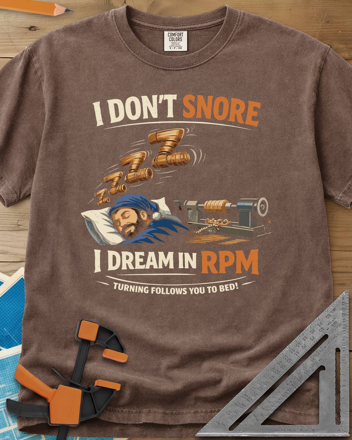 Dream in RPM heavyweight tee in Espresso, a sleeping woodturner in a nightcap, wooden Zs and a lathe