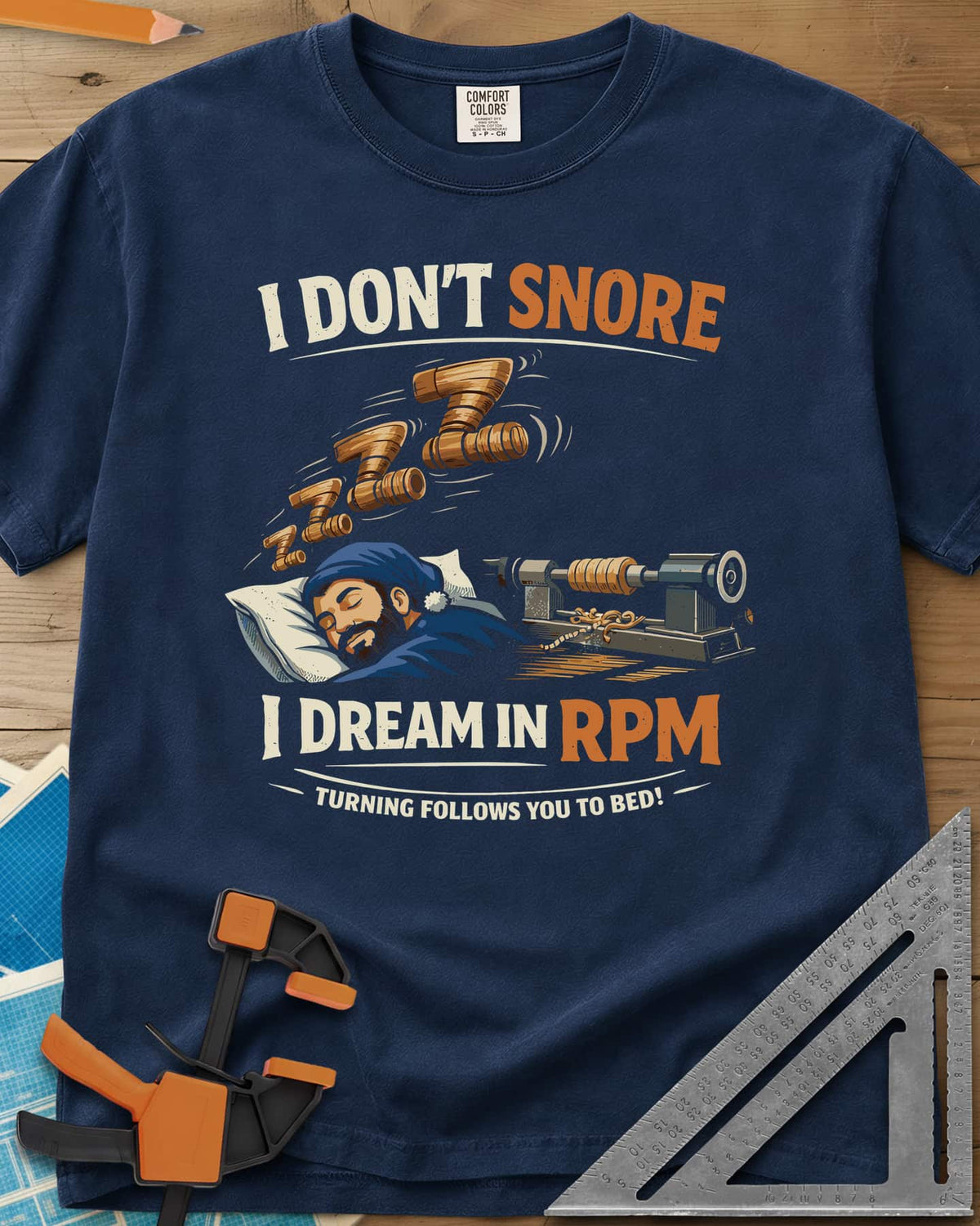 Dream in RPM heavyweight tee in Navy, a sleeping woodturner in a nightcap, wooden Zs and a lathe