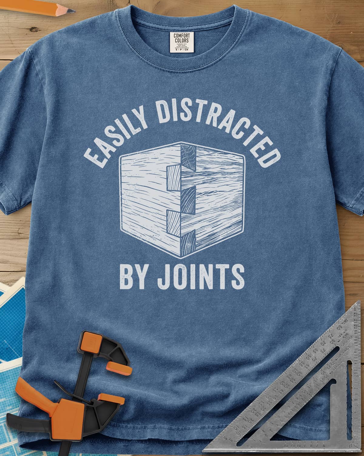 Easily Distracted by Joints heavyweight tee in Blue Jean, a woodcut-style dovetail joint at a box corner