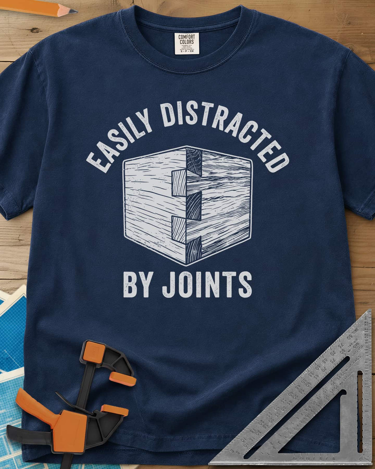Easily Distracted by Joints heavyweight tee in Navy, a woodcut-style dovetail joint at a box corner