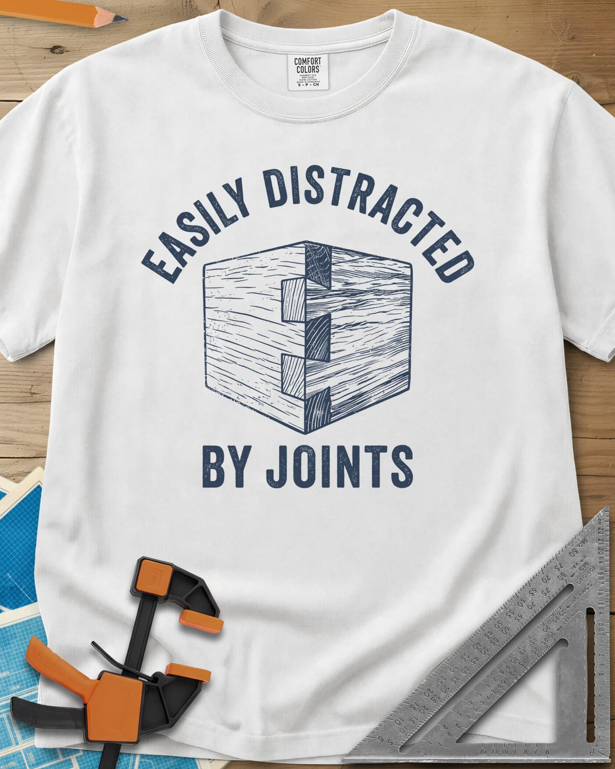 Easily Distracted by Joints heavyweight tee in White, a woodcut-style dovetail joint at a box corner
