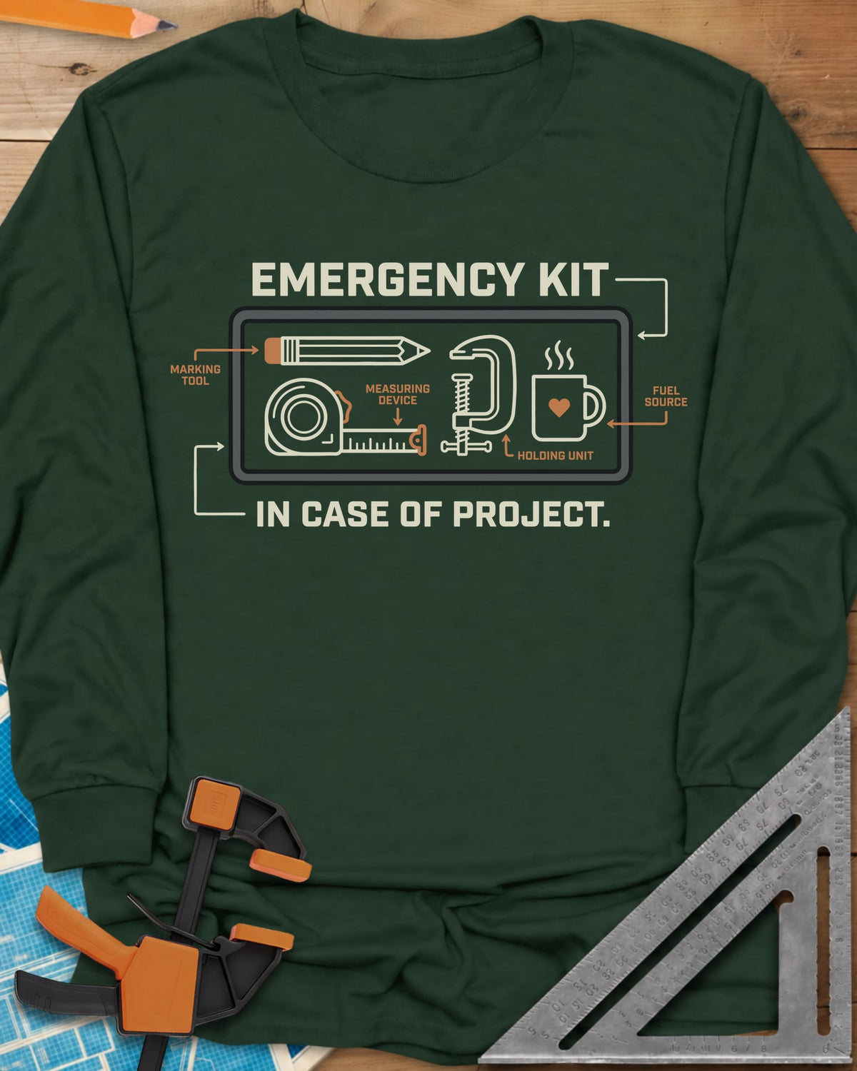 Emergency Kit Project long sleeve shirt in Forest Green, a labeled kit diagram: pencil, tape, clamp and heart mug