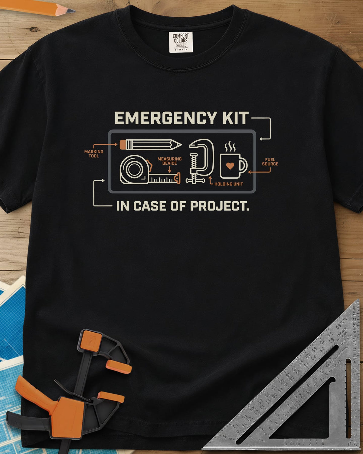 Emergency Kit Project heavyweight tee in Black, a labeled kit diagram: pencil, tape, clamp and heart mug