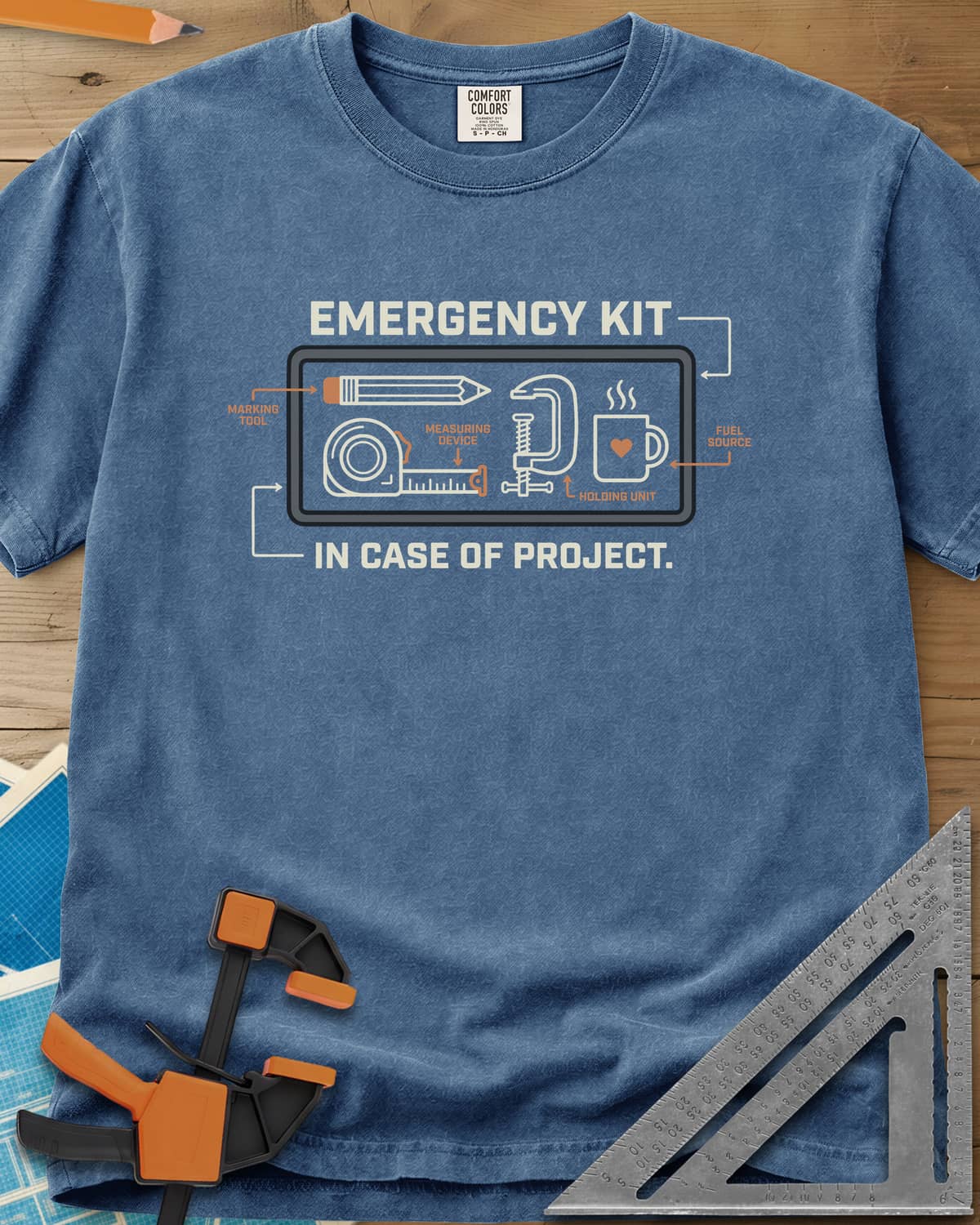 Emergency Kit Project heavyweight tee in Blue Jean, a labeled kit diagram: pencil, tape, clamp and heart mug