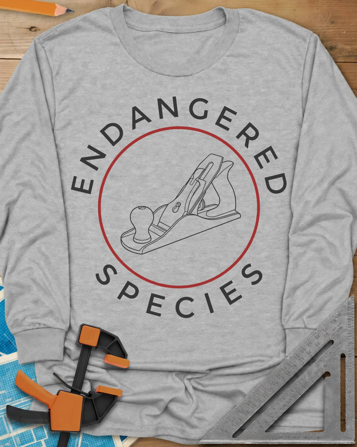 Endangered Species long sleeve shirt in Sport Grey, a hand plane line drawing inside a rust-red circle