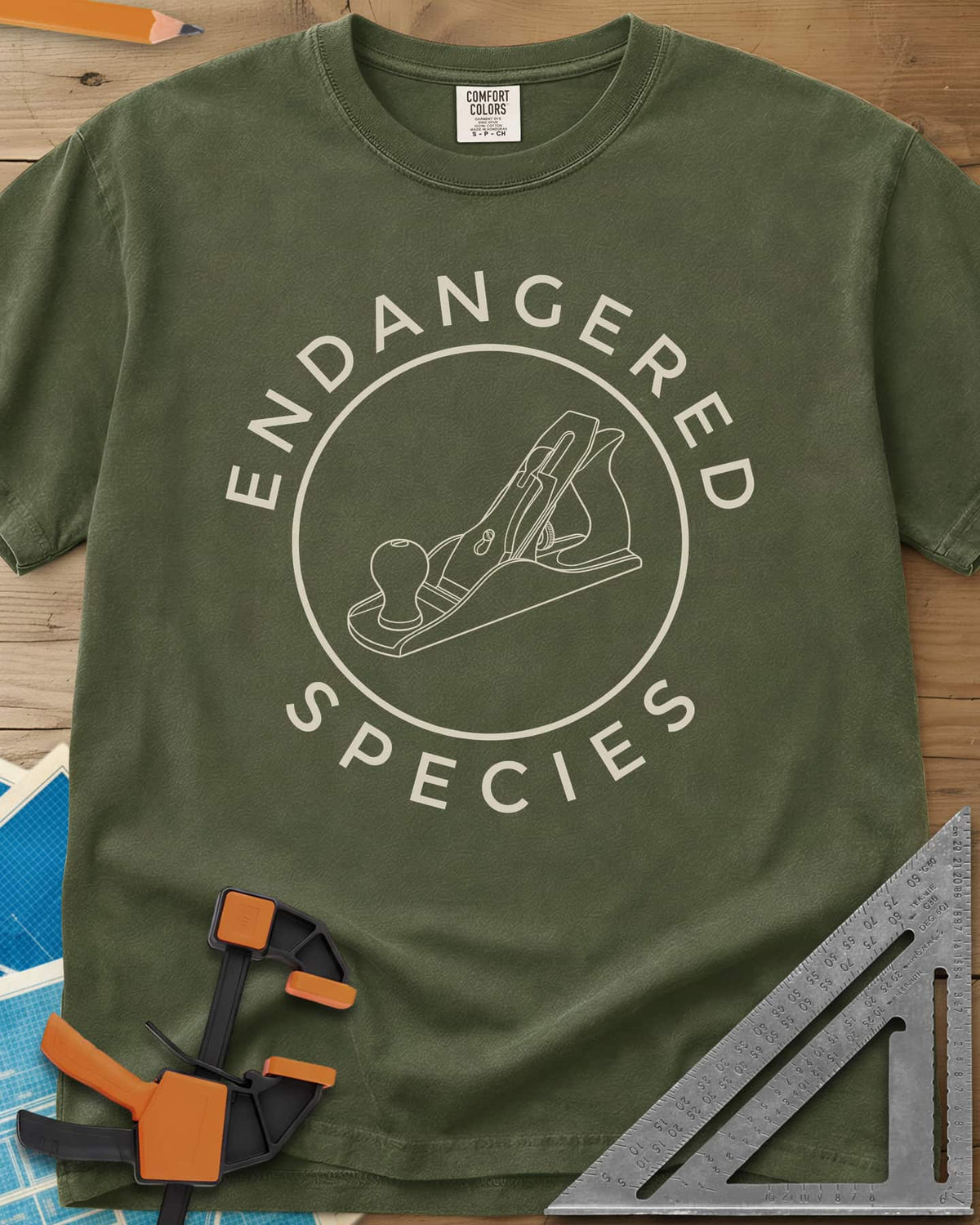 Endangered Species heavyweight tee in Hemp, a hand plane line drawing inside a rust-red circle