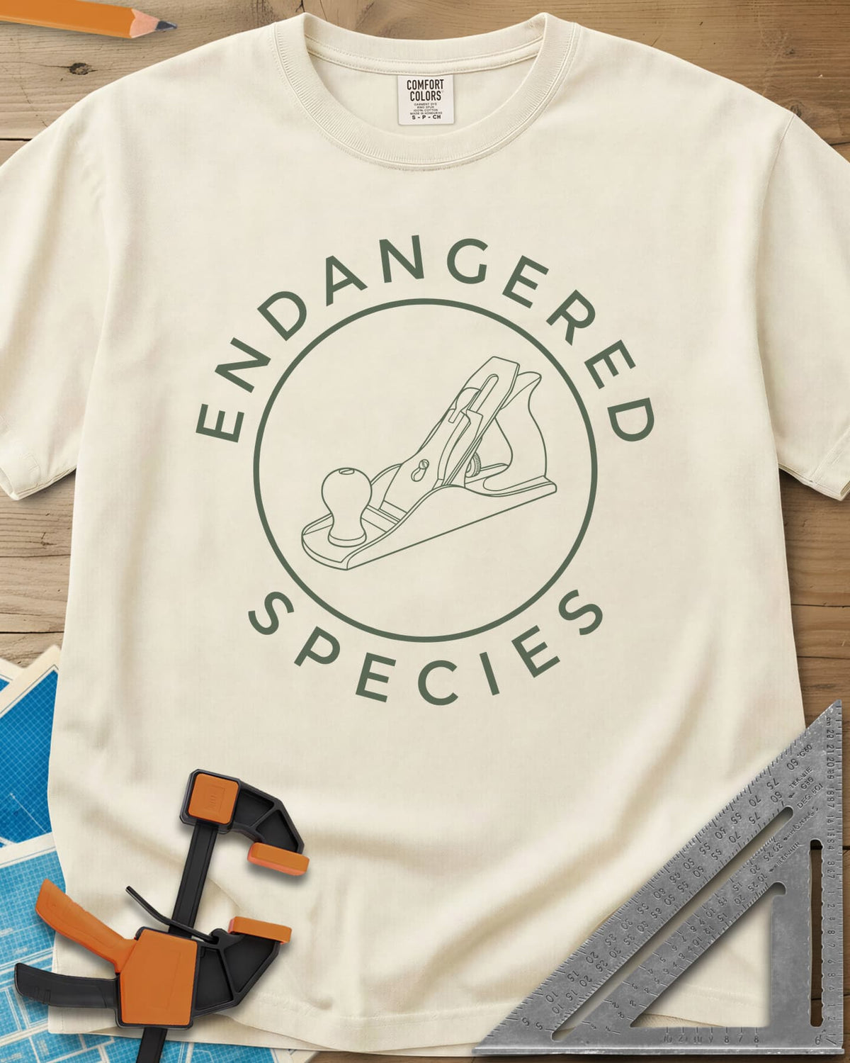 Endangered Species heavyweight tee in Ivory, a hand plane line drawing inside a rust-red circle