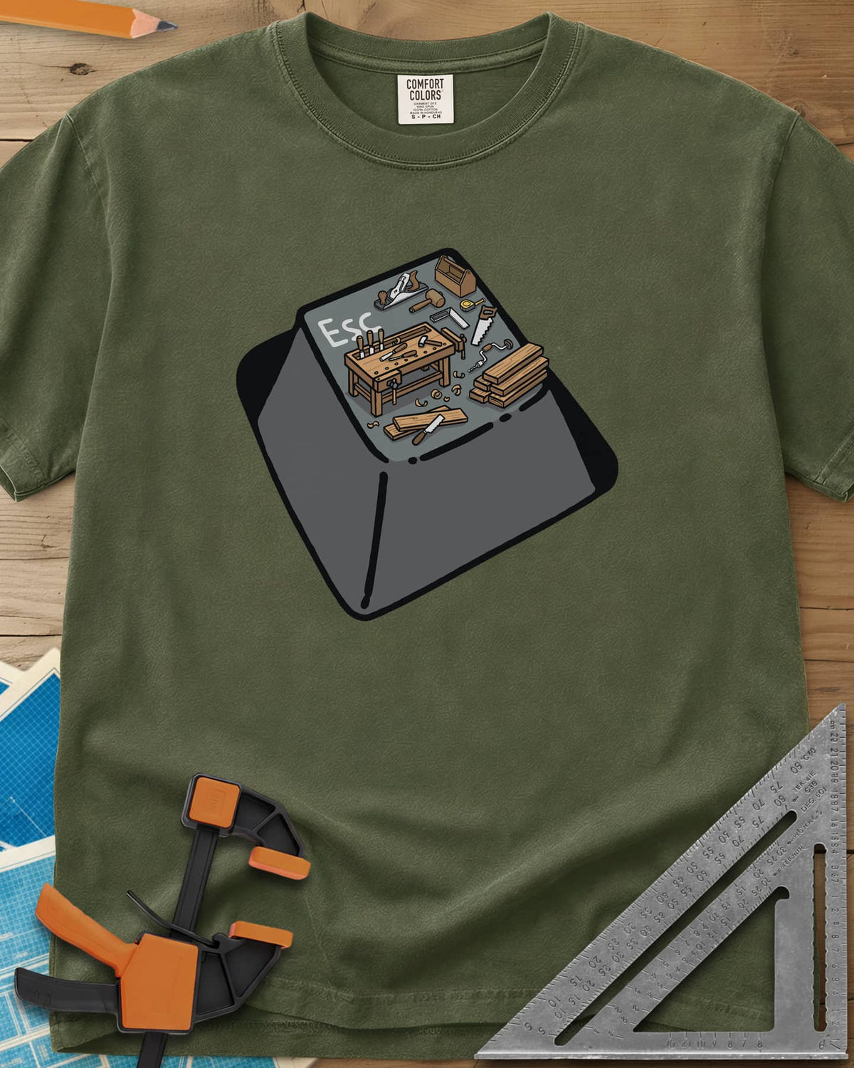 Escape To Shop heavyweight tee in Hemp, a keyboard Esc key with a tiny woodshop scene on top