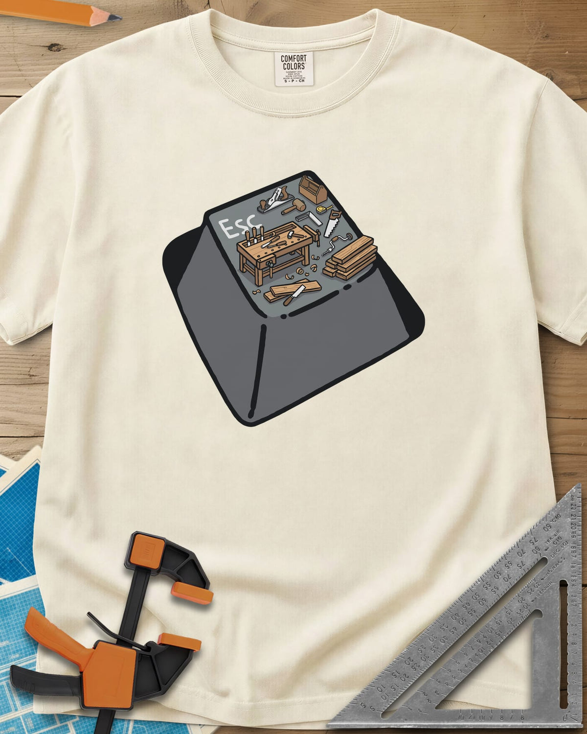 Escape To Shop heavyweight tee in Ivory, a keyboard Esc key with a tiny woodshop scene on top