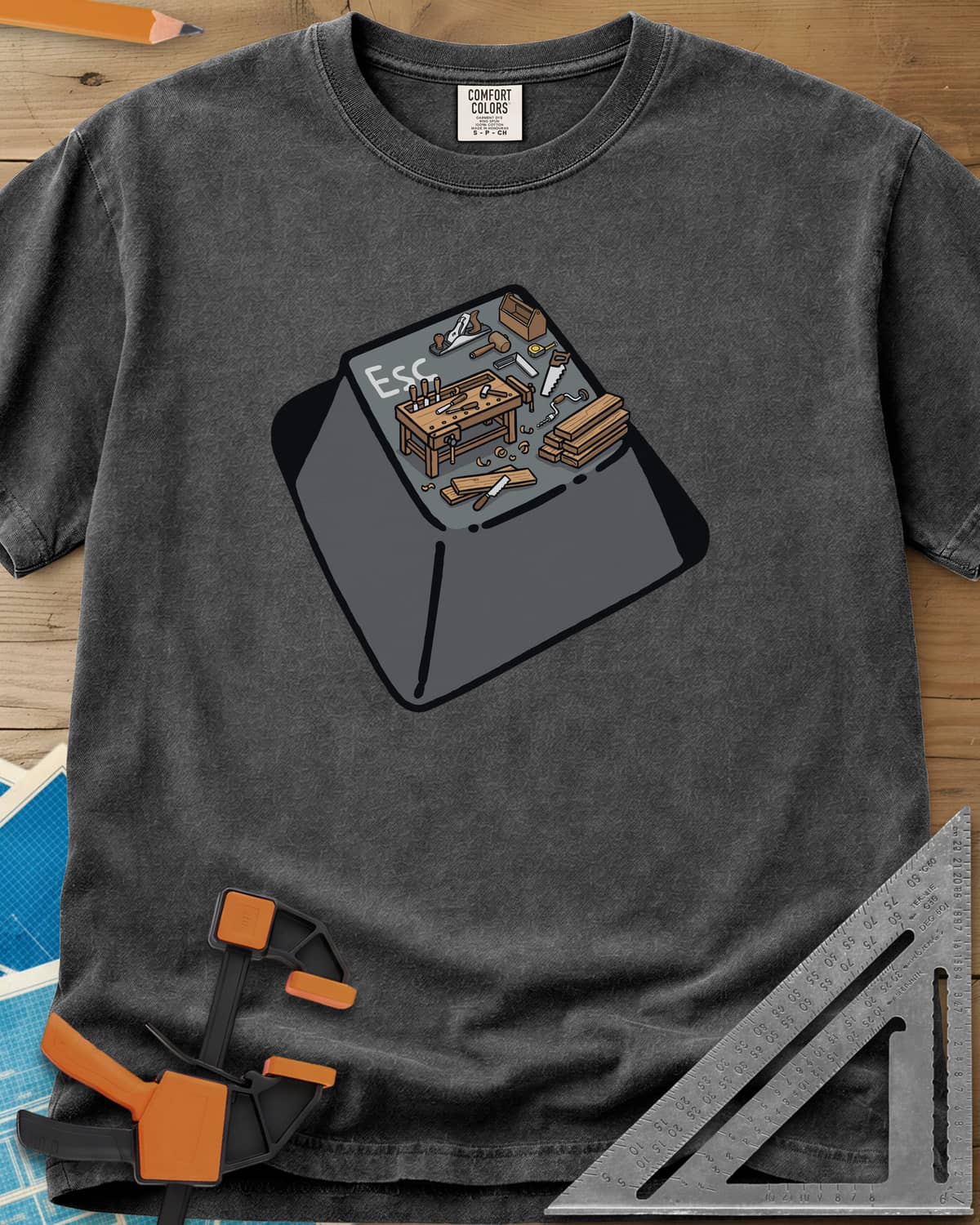 Escape To Shop heavyweight tee in Pepper, a keyboard Esc key with a tiny woodshop scene on top