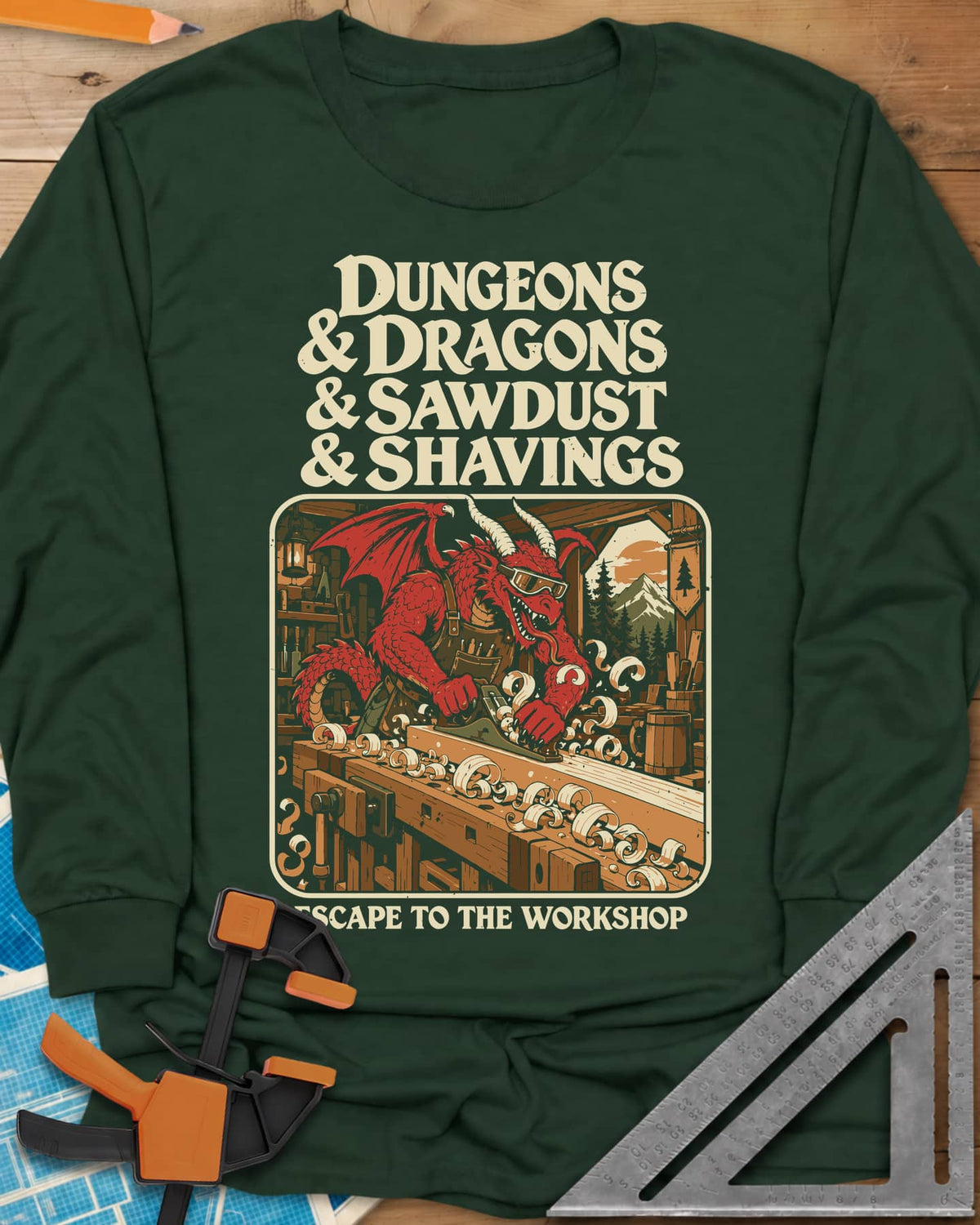 Escape To The Workshop long sleeve shirt in Forest Green, a red dragon in goggles planing a board at a workbench