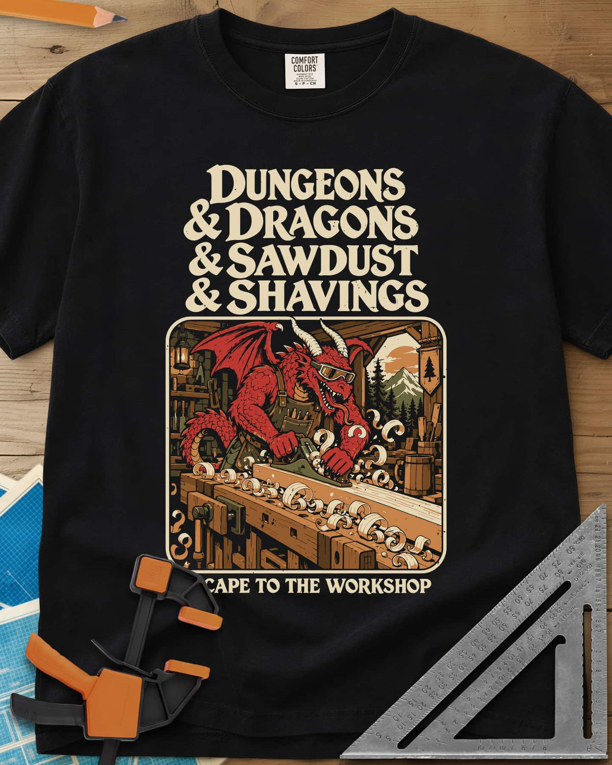 Escape To The Workshop heavyweight tee in Black, a red dragon in goggles planing a board at a workbench