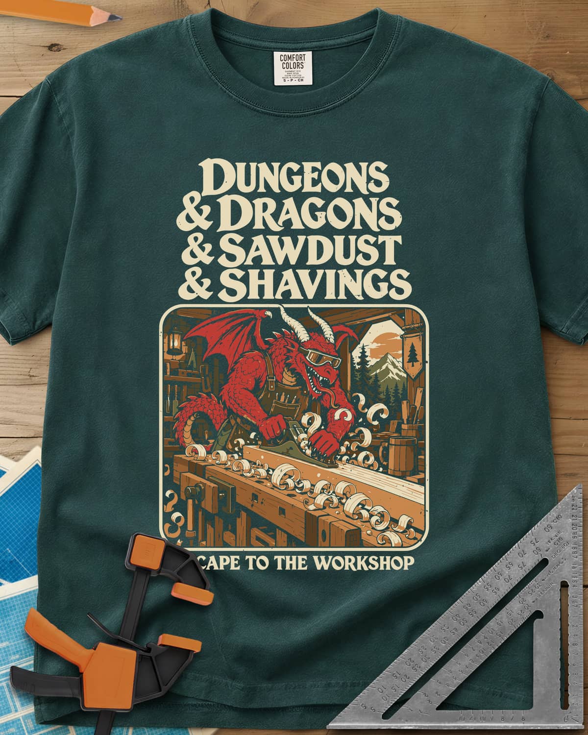 Escape To The Workshop heavyweight tee in Blue Spruce, a red dragon in goggles planing a board at a workbench