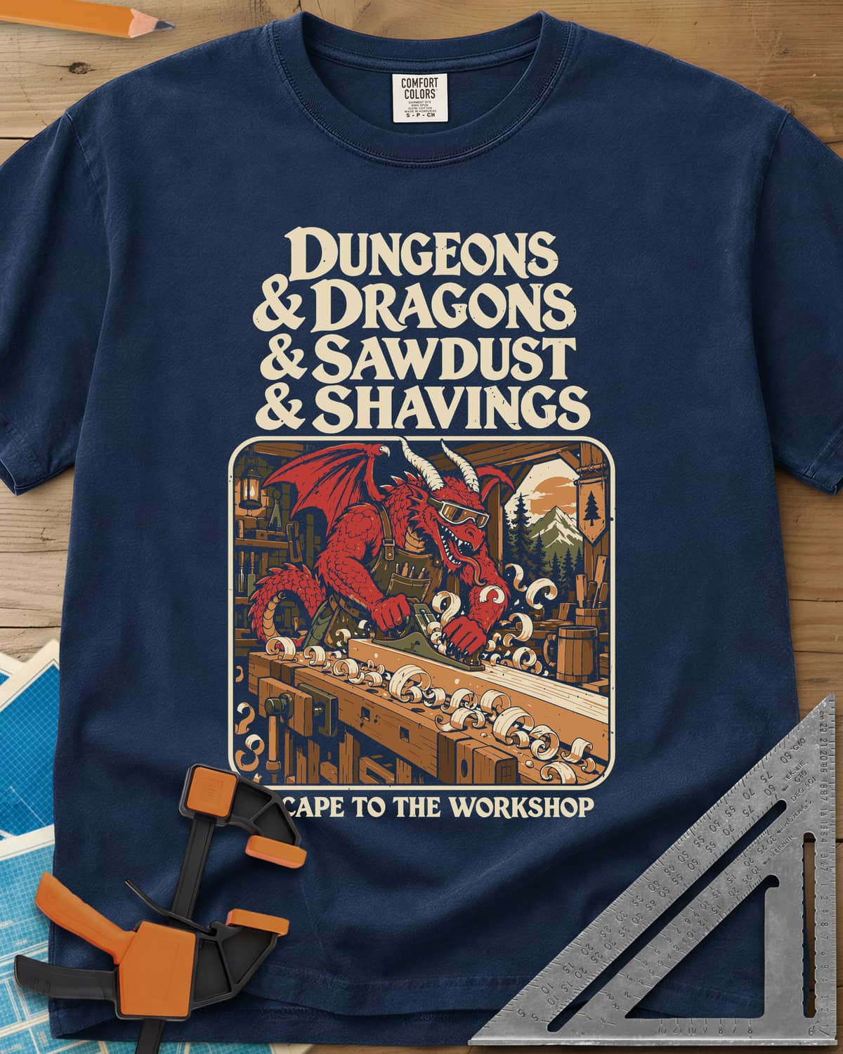 Escape To The Workshop heavyweight tee in Navy, a red dragon in goggles planing a board at a workbench
