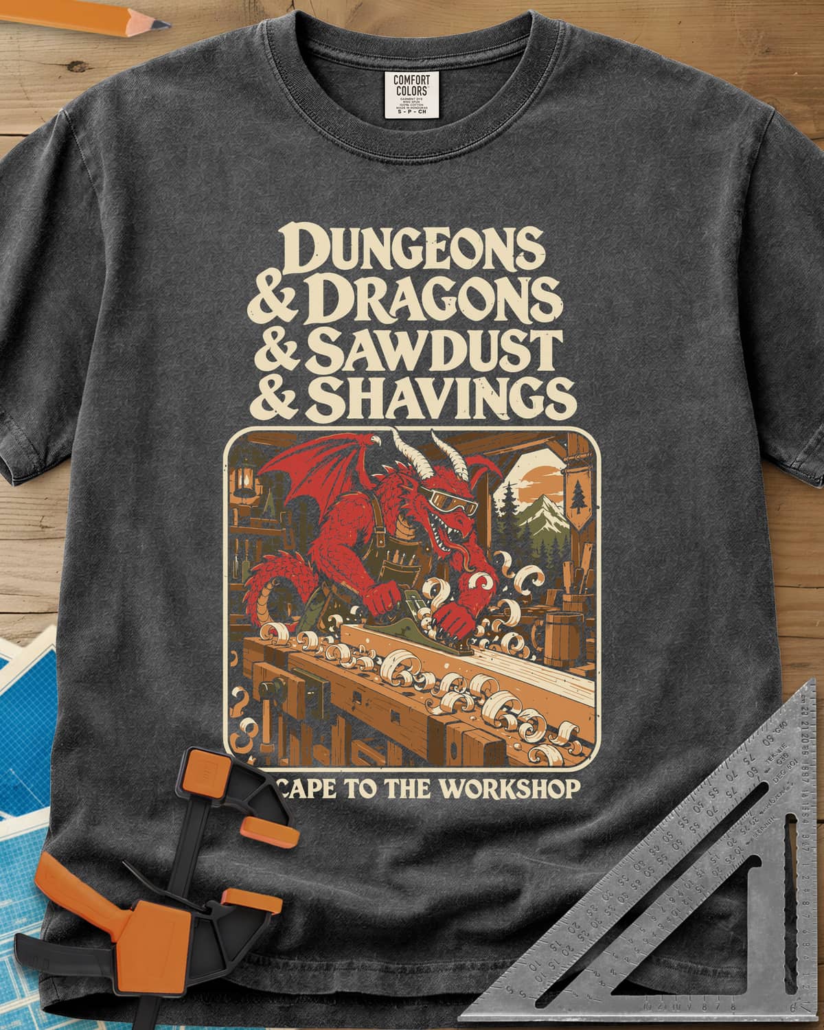 Escape To The Workshop heavyweight tee in Pepper, a red dragon in goggles planing a board at a workbench