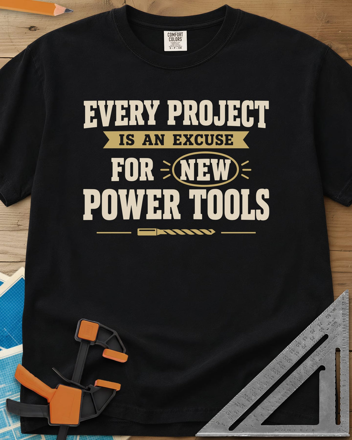 Every Project Is An Excuse heavyweight tee in Black, slogan with a ribbon banner, circled NEW and a drill bit