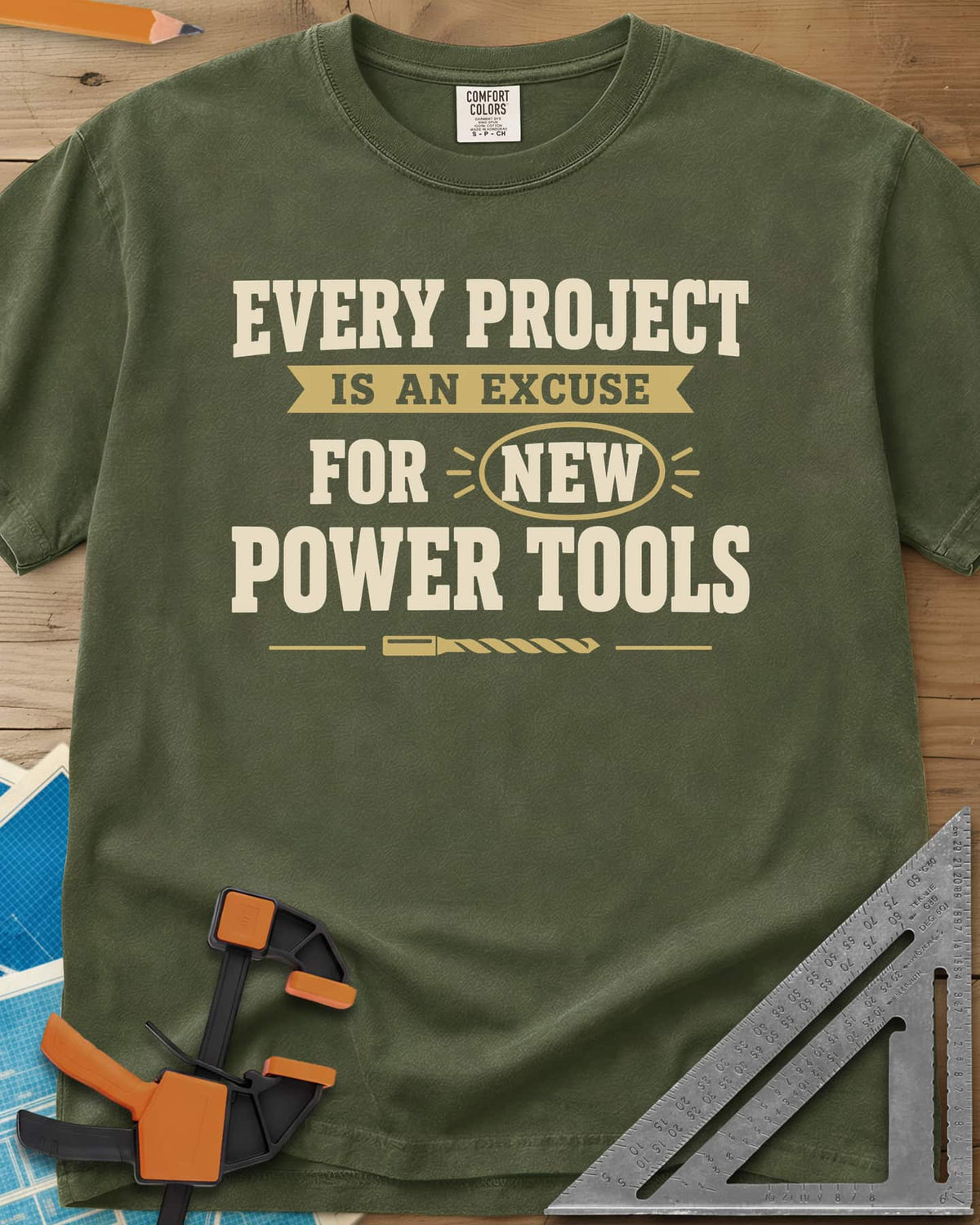 Every Project Is An Excuse heavyweight tee in Hemp, slogan with a ribbon banner, circled NEW and a drill bit