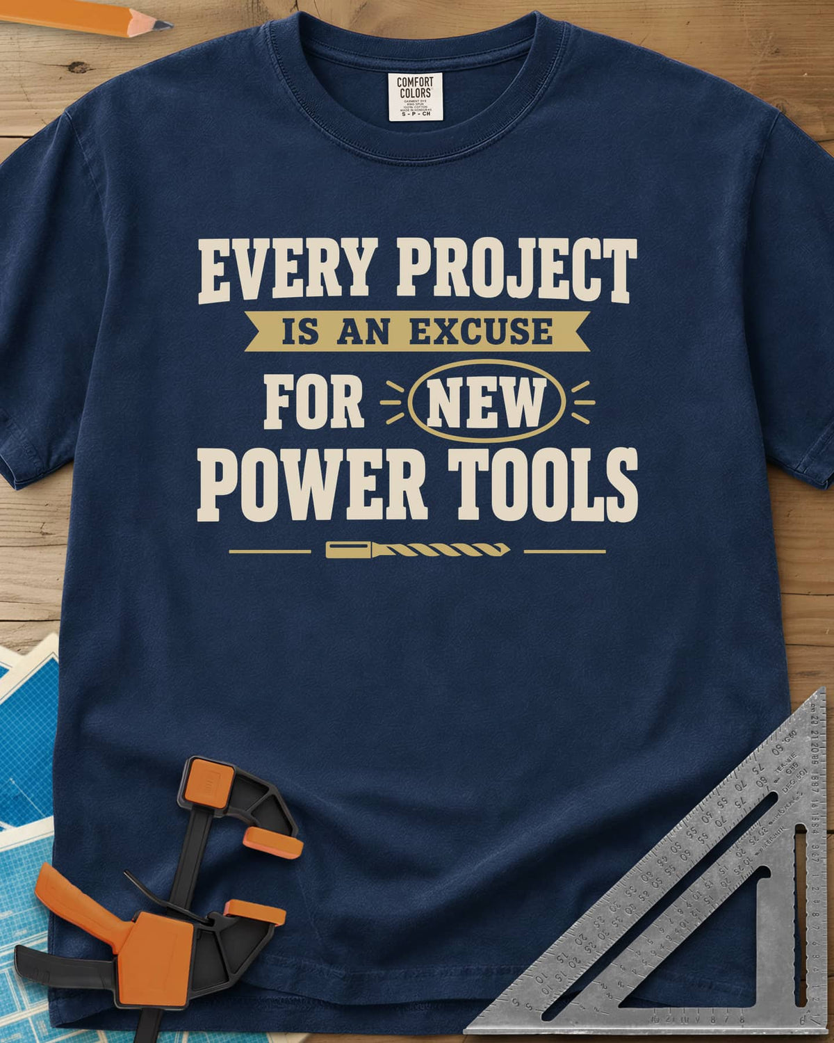 Every Project Is An Excuse heavyweight tee in Navy, slogan with a ribbon banner, circled NEW and a drill bit
