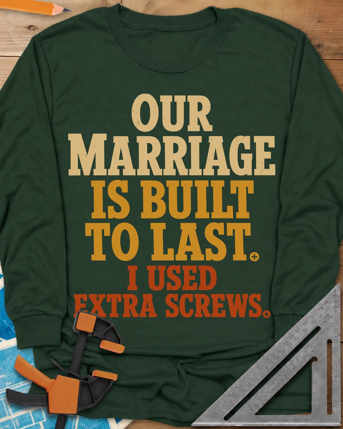Extra Screws long sleeve shirt in Forest Green, stacked lettering in cream, mustard and rust with tiny screw heads