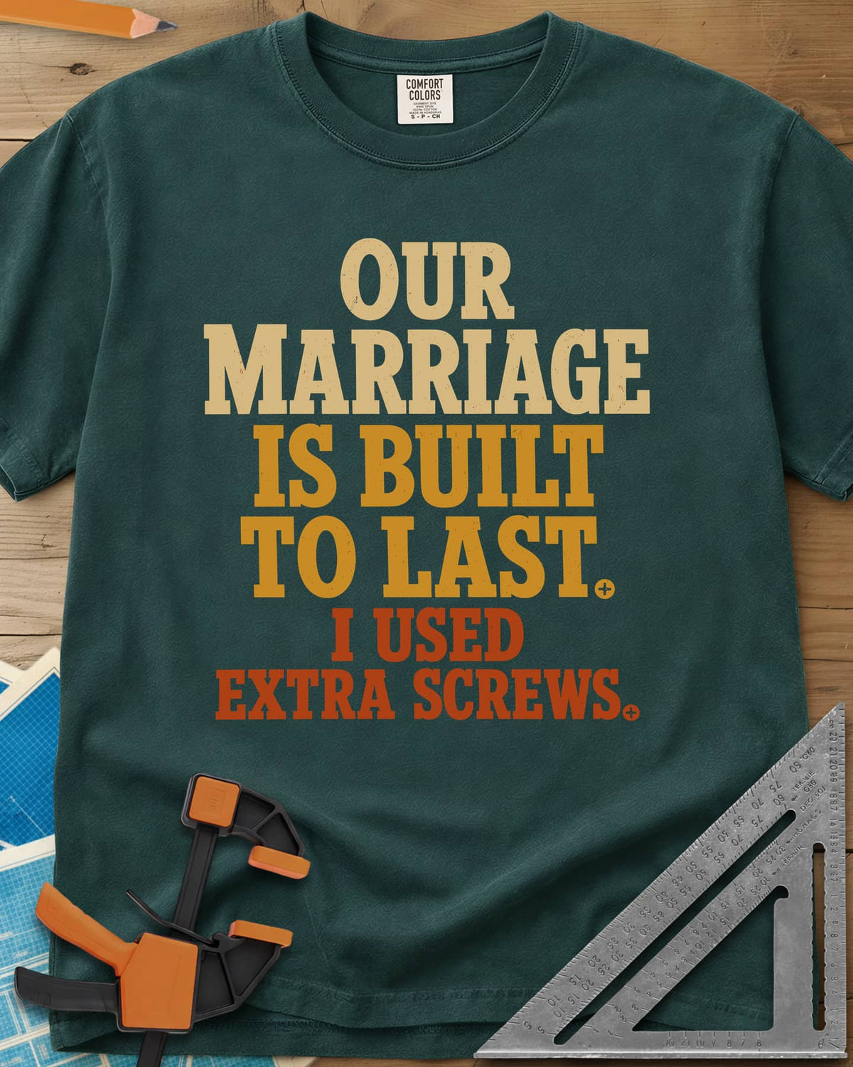 Extra Screws heavyweight tee in Blue Spruce, stacked lettering in cream, mustard and rust with tiny screw heads