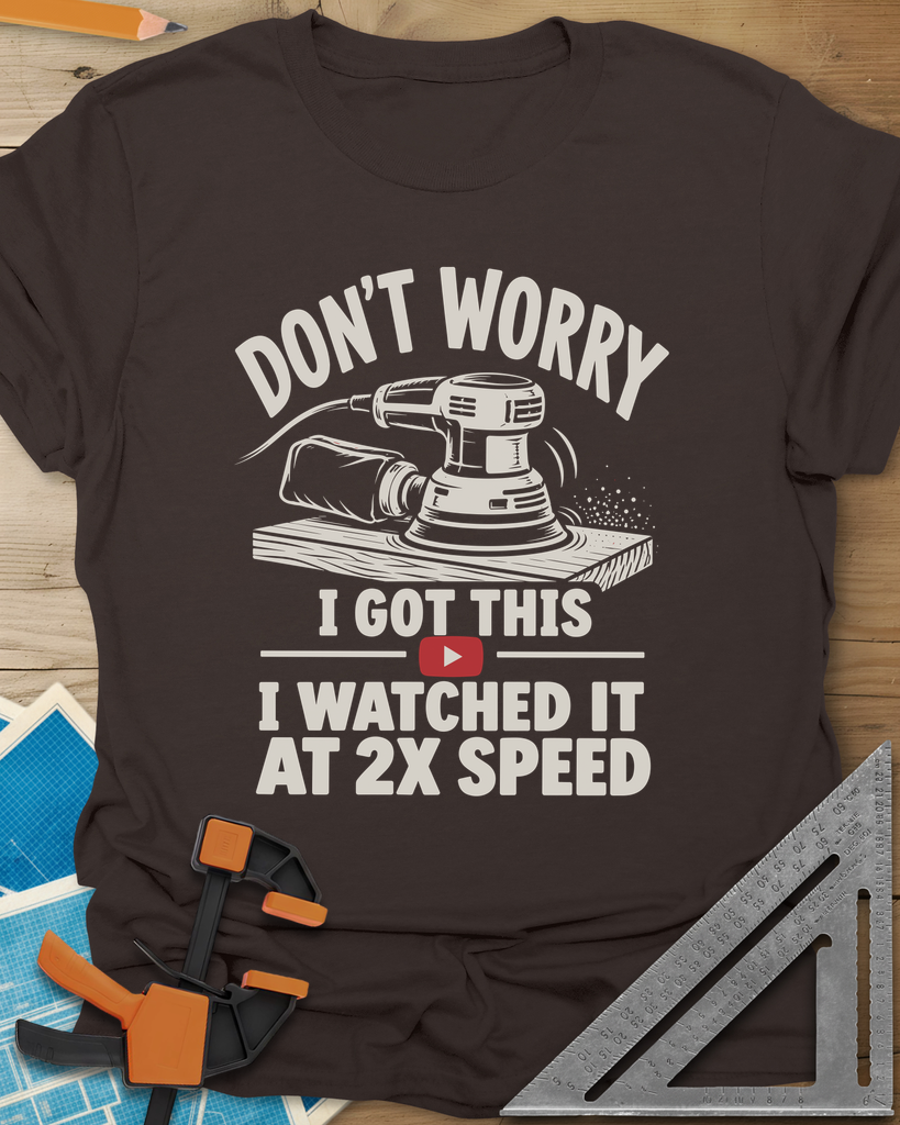 2x Speed t-shirt in Dark Chocolate, an orbital sander on a board beside a red video play button