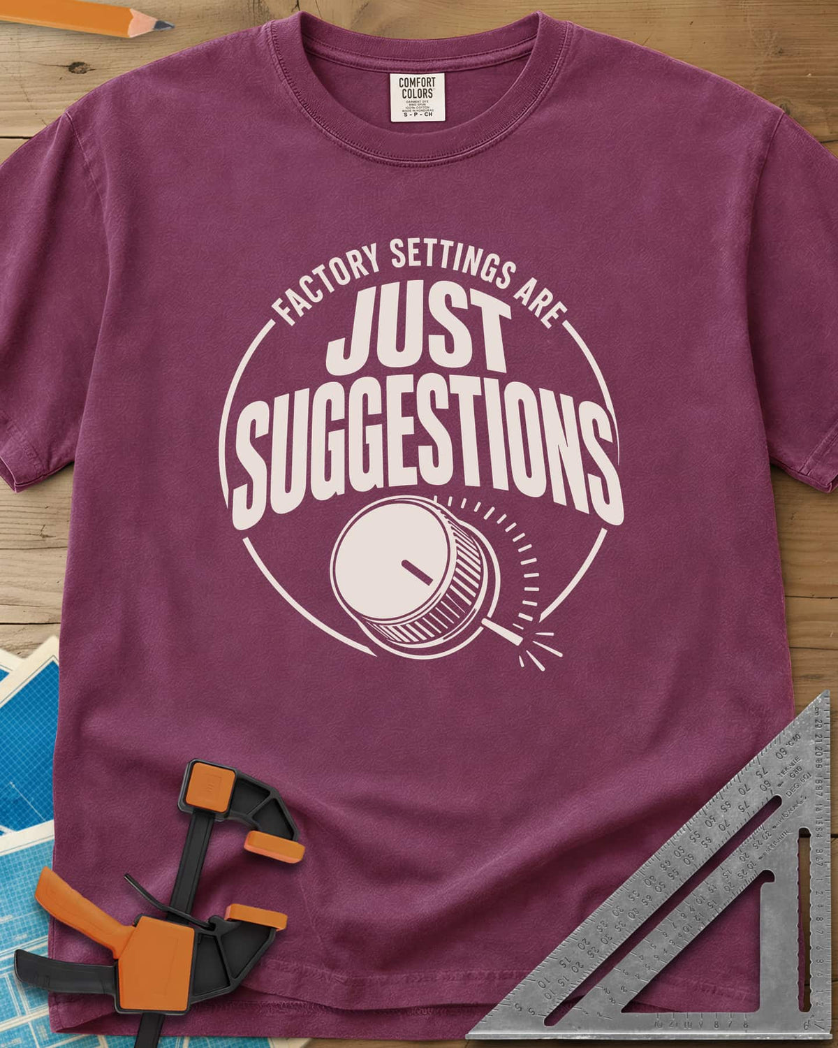 Factory Suggestions heavyweight tee in Berry, a round badge with a dial knob and tick marks