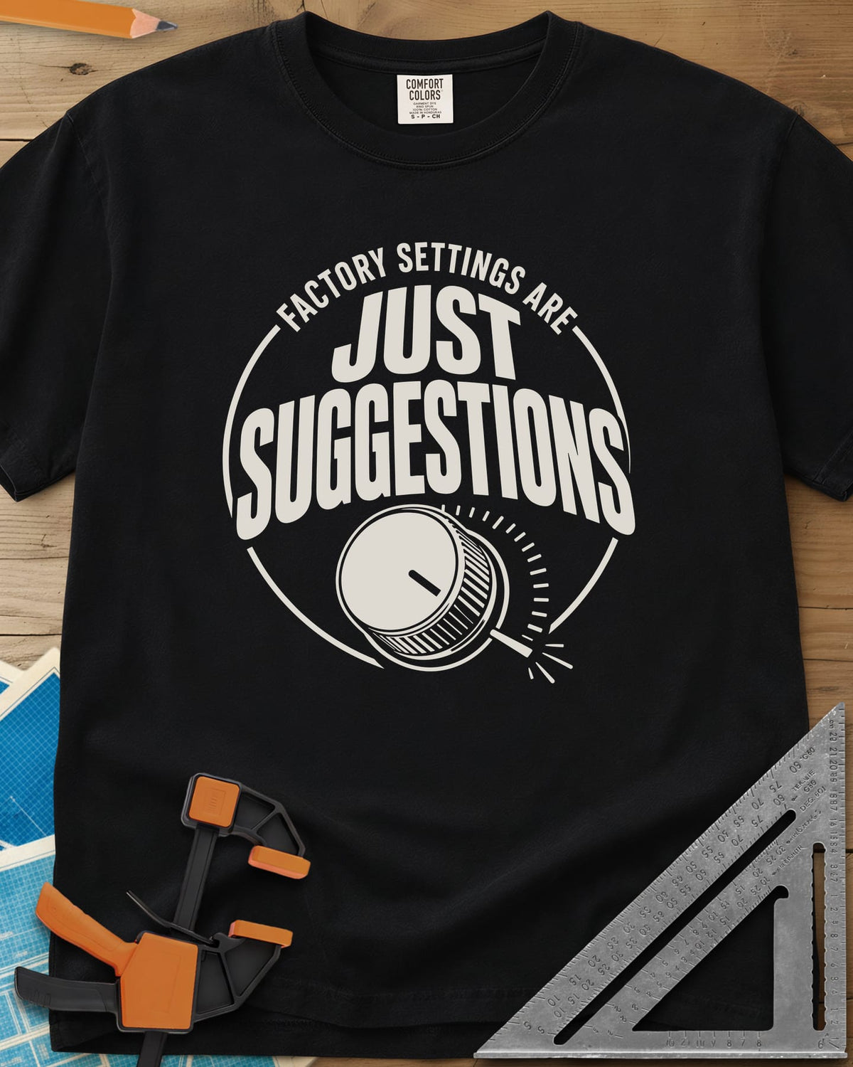 Factory Suggestions heavyweight tee in Black, a round badge with a dial knob and tick marks