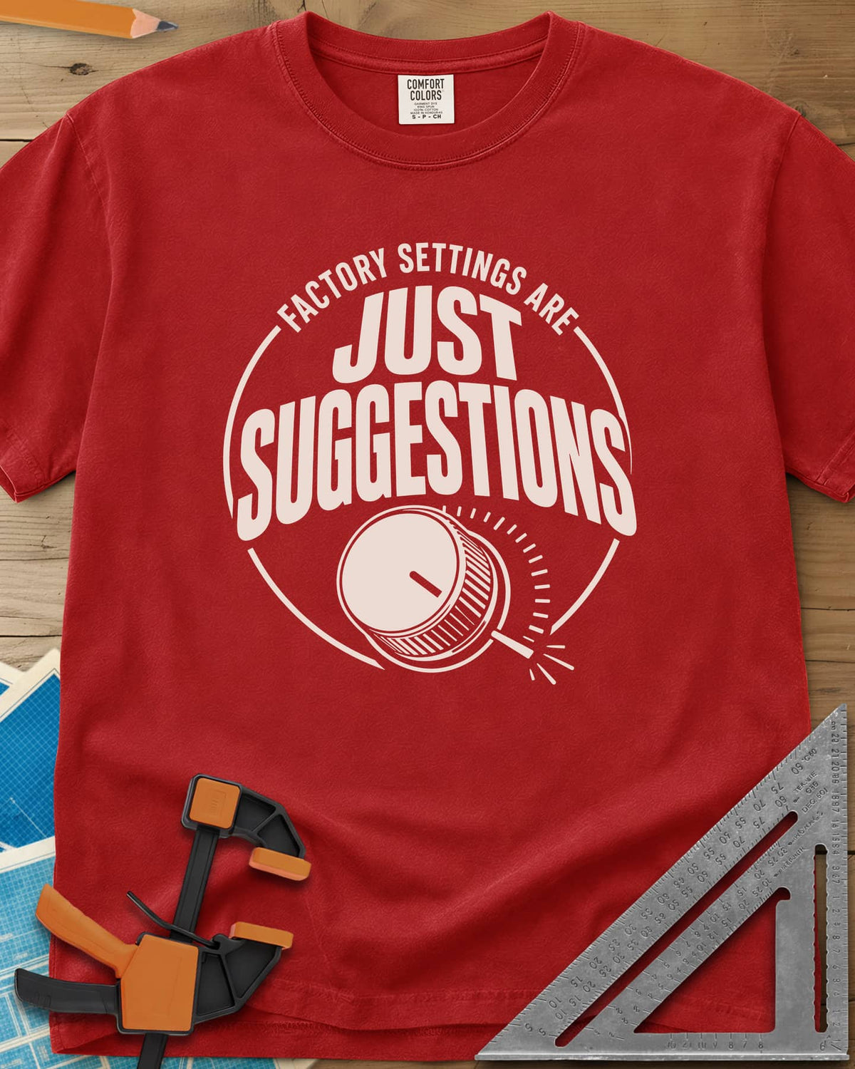 Factory Suggestions heavyweight tee in Red, a round badge with a dial knob and tick marks