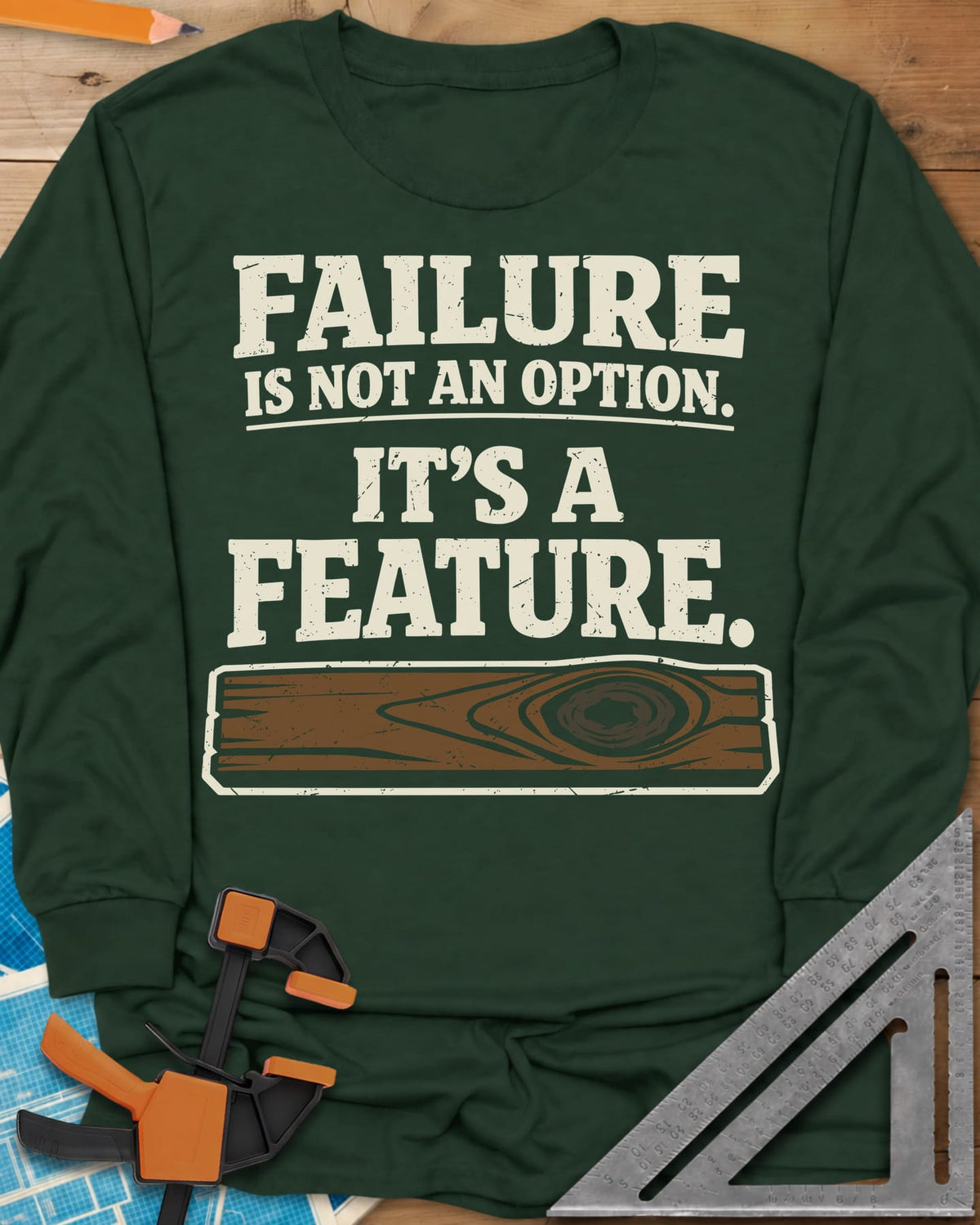 Failure Is A Feature long sleeve shirt in Forest Green, a knotty plank with a swirling knot under the slogan