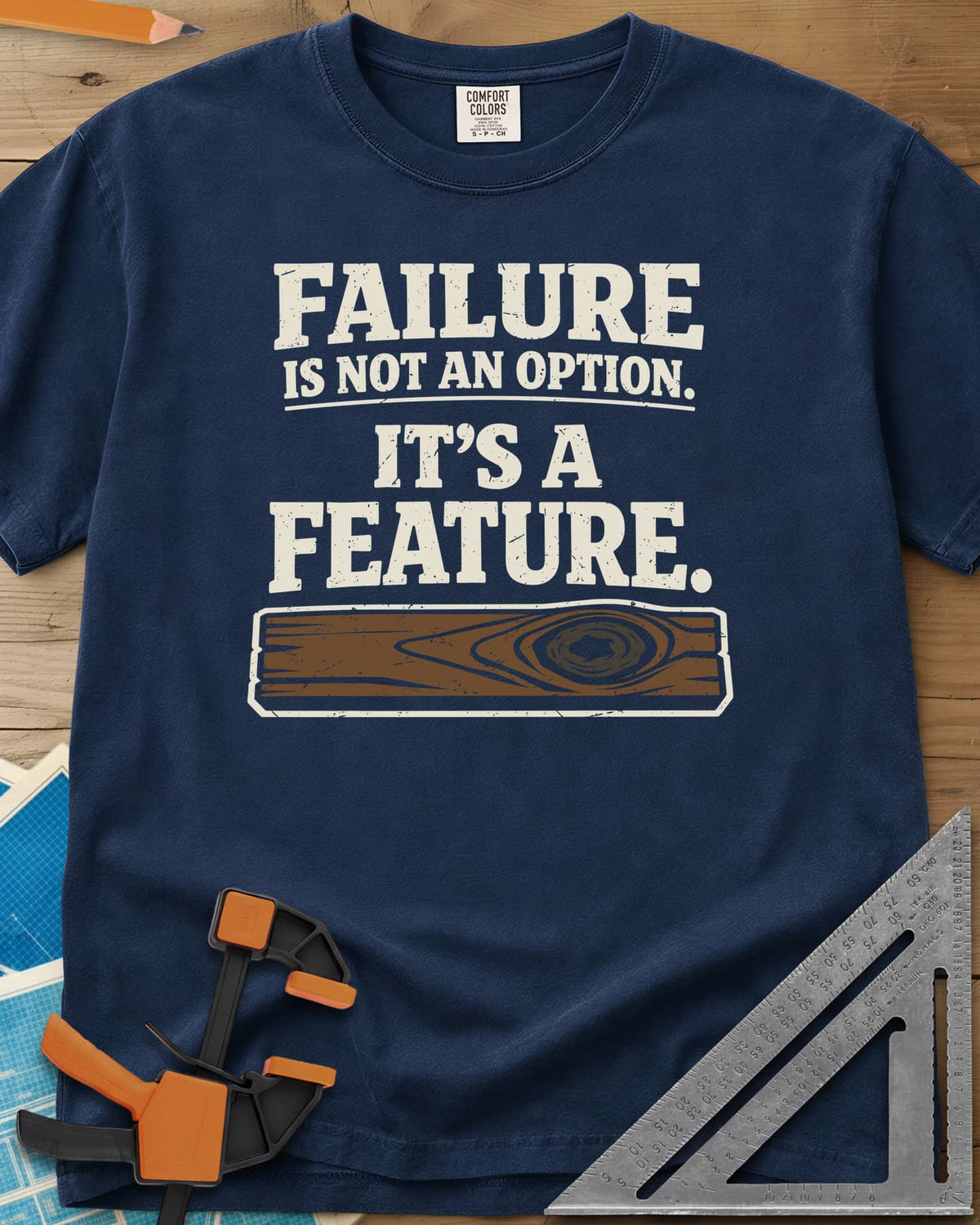 Failure Is A Feature heavyweight tee in Navy, a knotty plank with a swirling knot under the slogan
