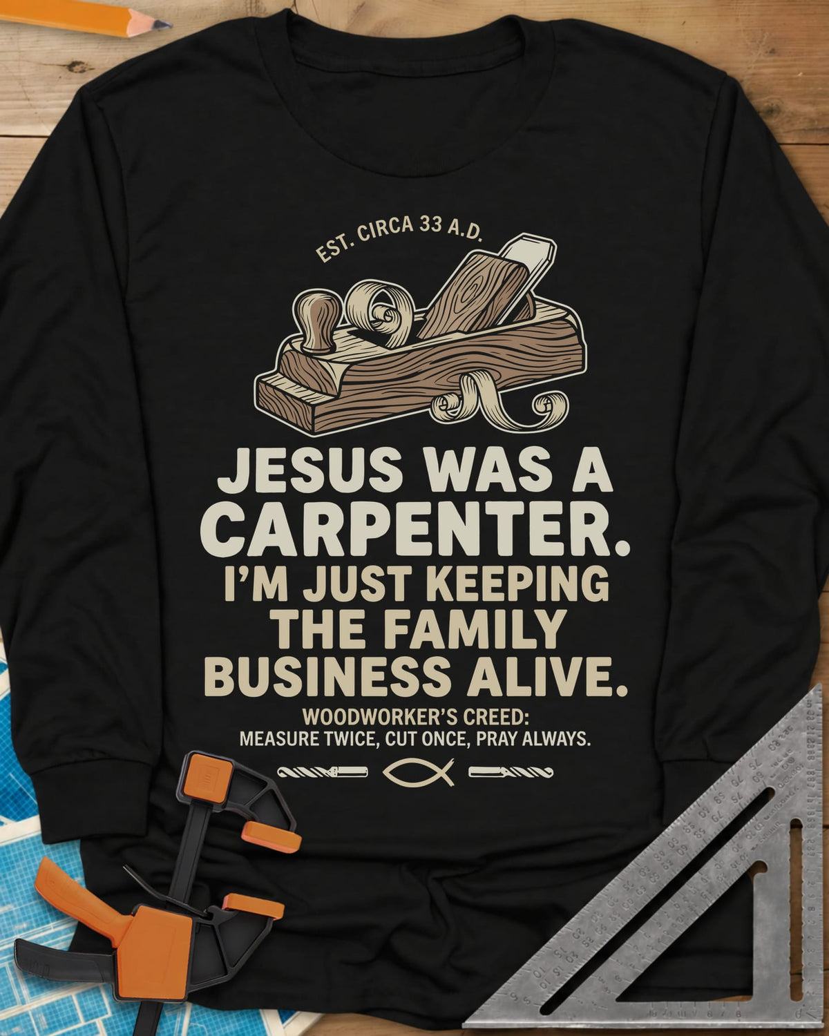 Family Business Carpenter long sleeve shirt in Black, a wooden hand plane with curled shavings and a small fish symbol