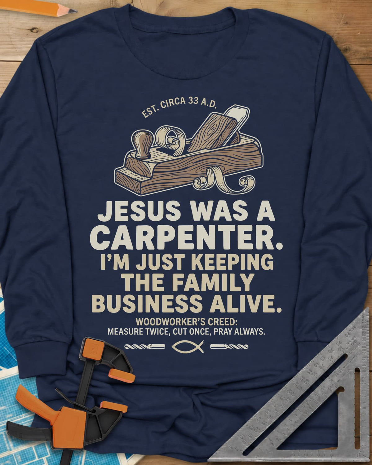 Family Business Carpenter long sleeve shirt in Navy, a wooden hand plane with curled shavings and a small fish symbol