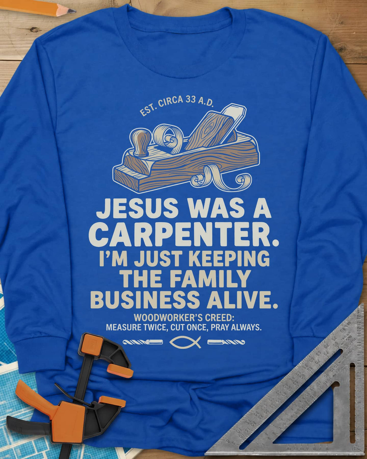 Family Business Carpenter long sleeve shirt in Royal, a wooden hand plane with curled shavings and a small fish symbol