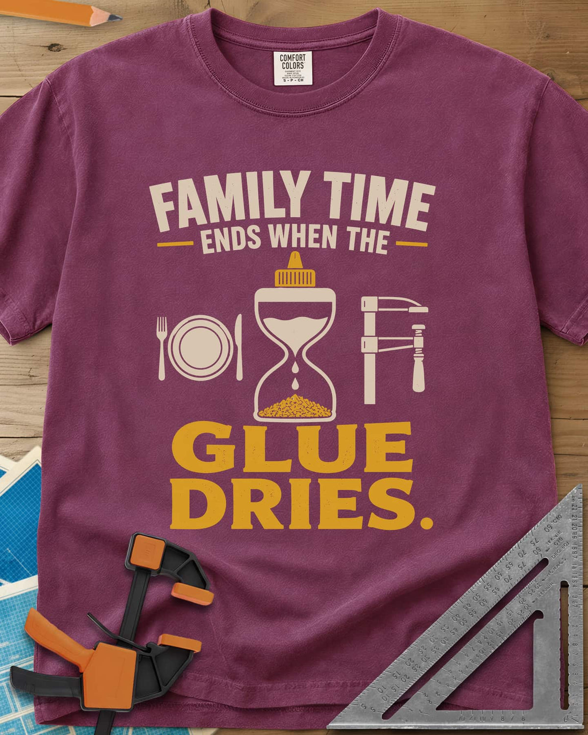Family Time Ends When The Glue Dries heavyweight tee in Berry, a place setting, a glue-bottle hourglass and a bar clamp
