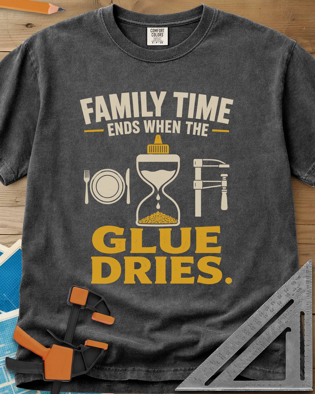 Family Time Ends When The Glue Dries heavyweight tee in Pepper, a place setting, a glue-bottle hourglass and a bar clamp