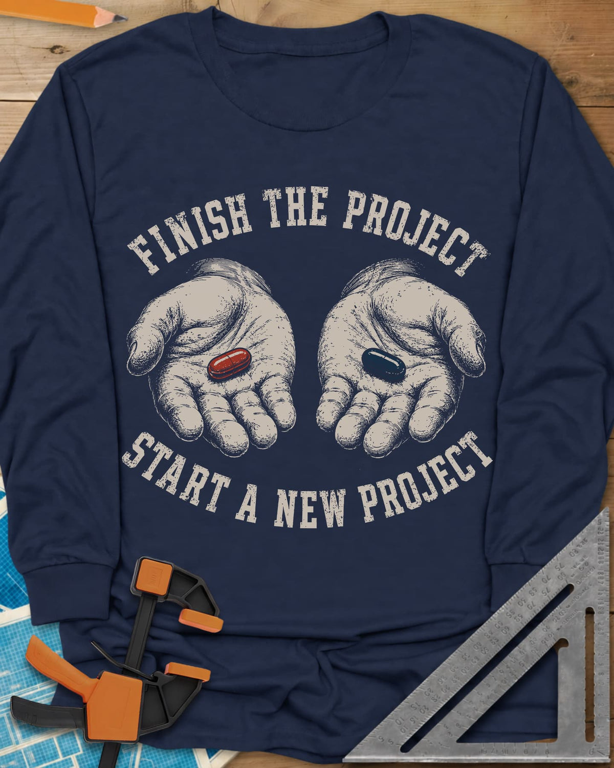 Finish The Project long sleeve shirt in Navy, two open hands holding a red pill and a dark blue pill