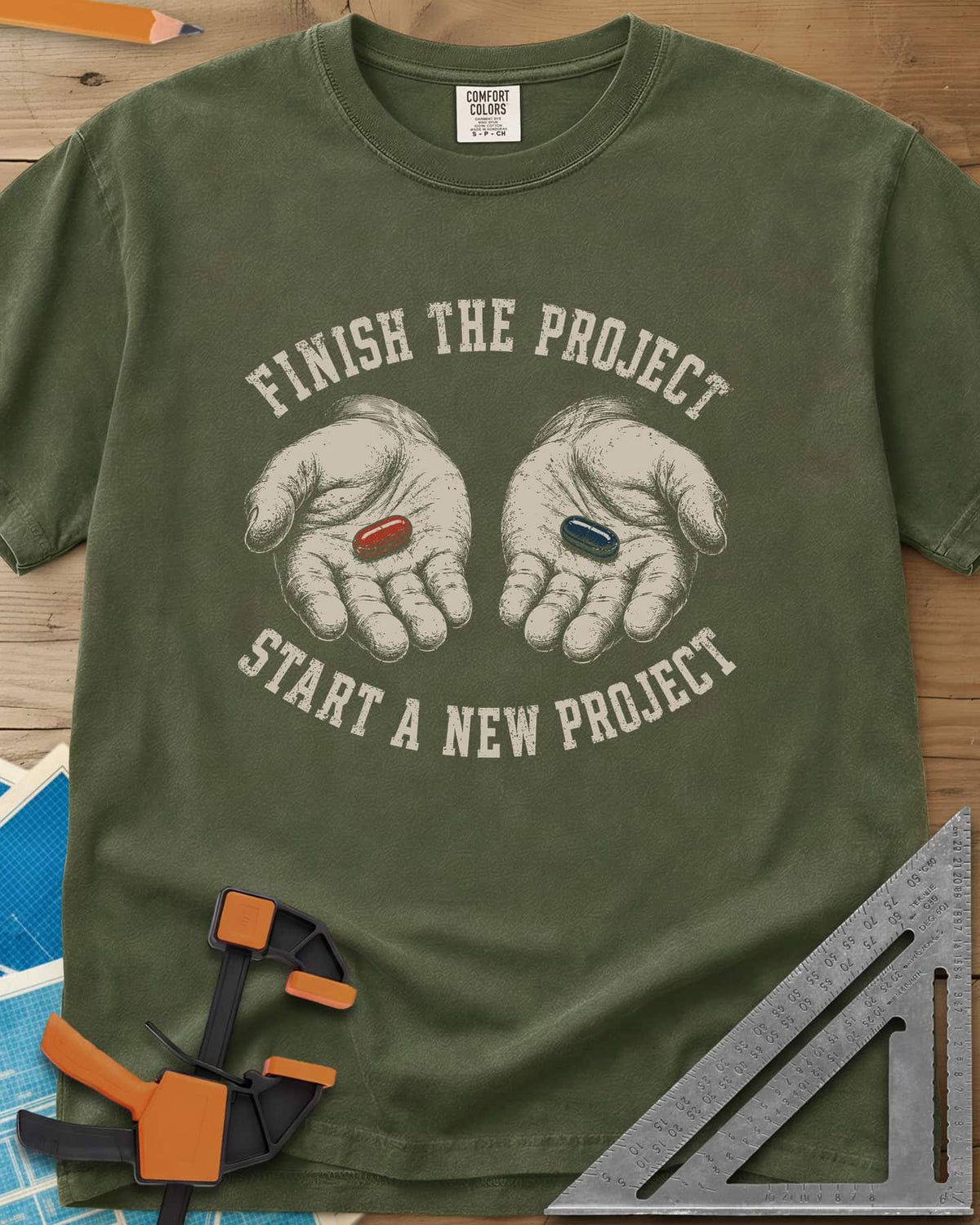 Finish The Project heavyweight tee in Hemp, two open hands holding a red pill and a dark blue pill