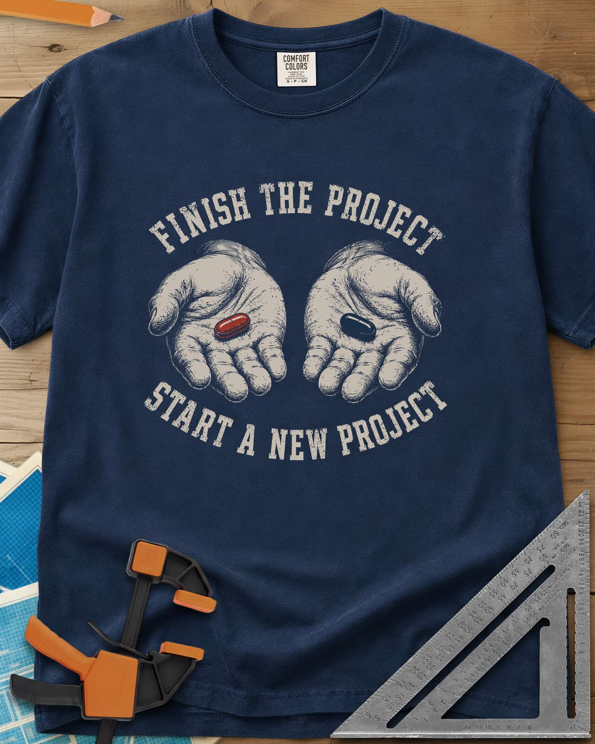 Finish The Project heavyweight tee in Navy, two open hands holding a red pill and a dark blue pill