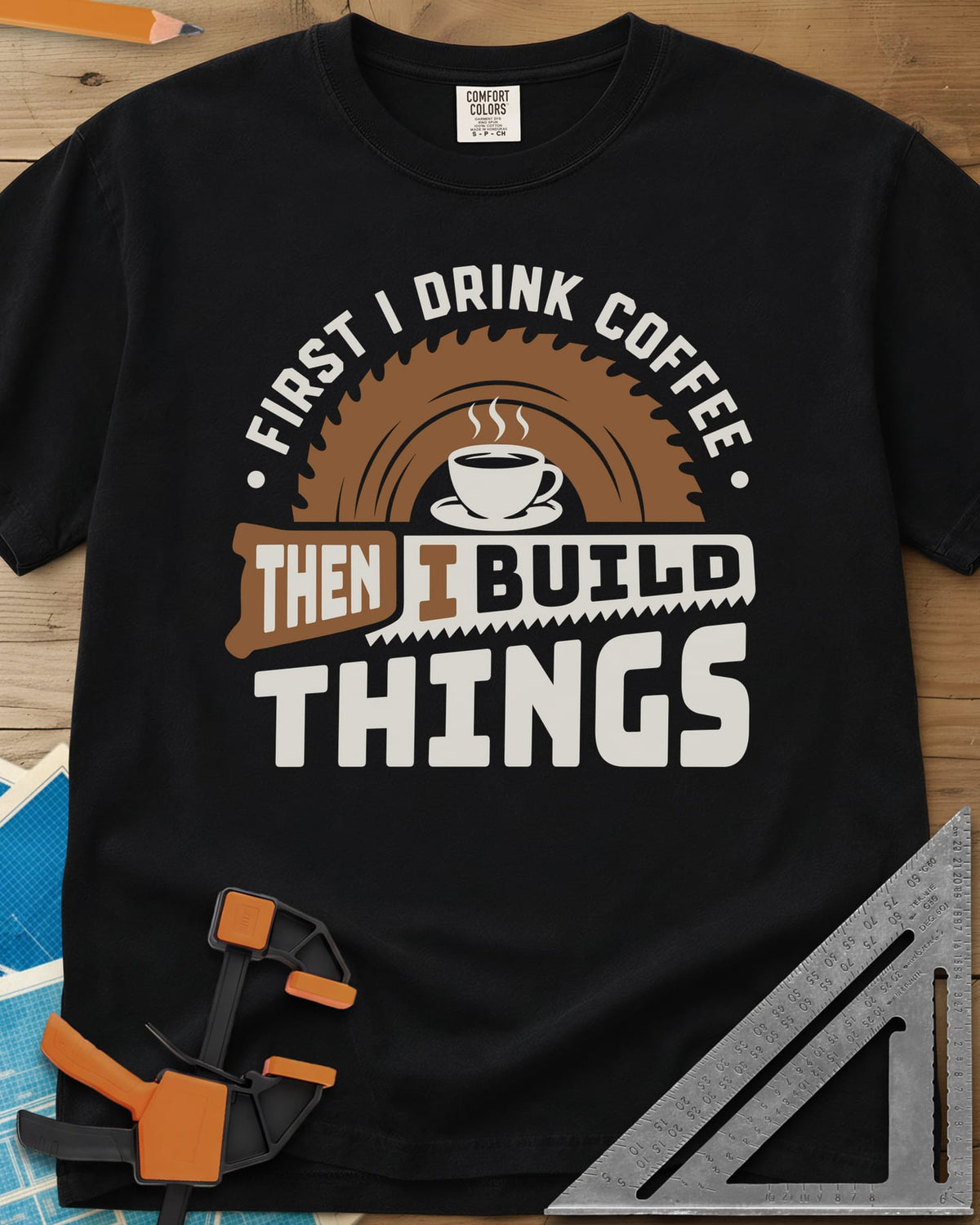 First I Drink Coffee Then I Build Things heavyweight tee in Black, a steaming cup before a saw blade, with a handsaw through