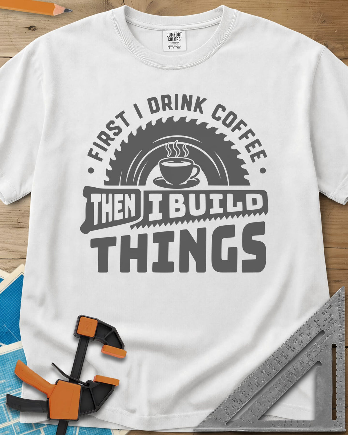 First I Drink Coffee Then I Build Things heavyweight tee in White, a steaming cup before a saw blade, with a handsaw through