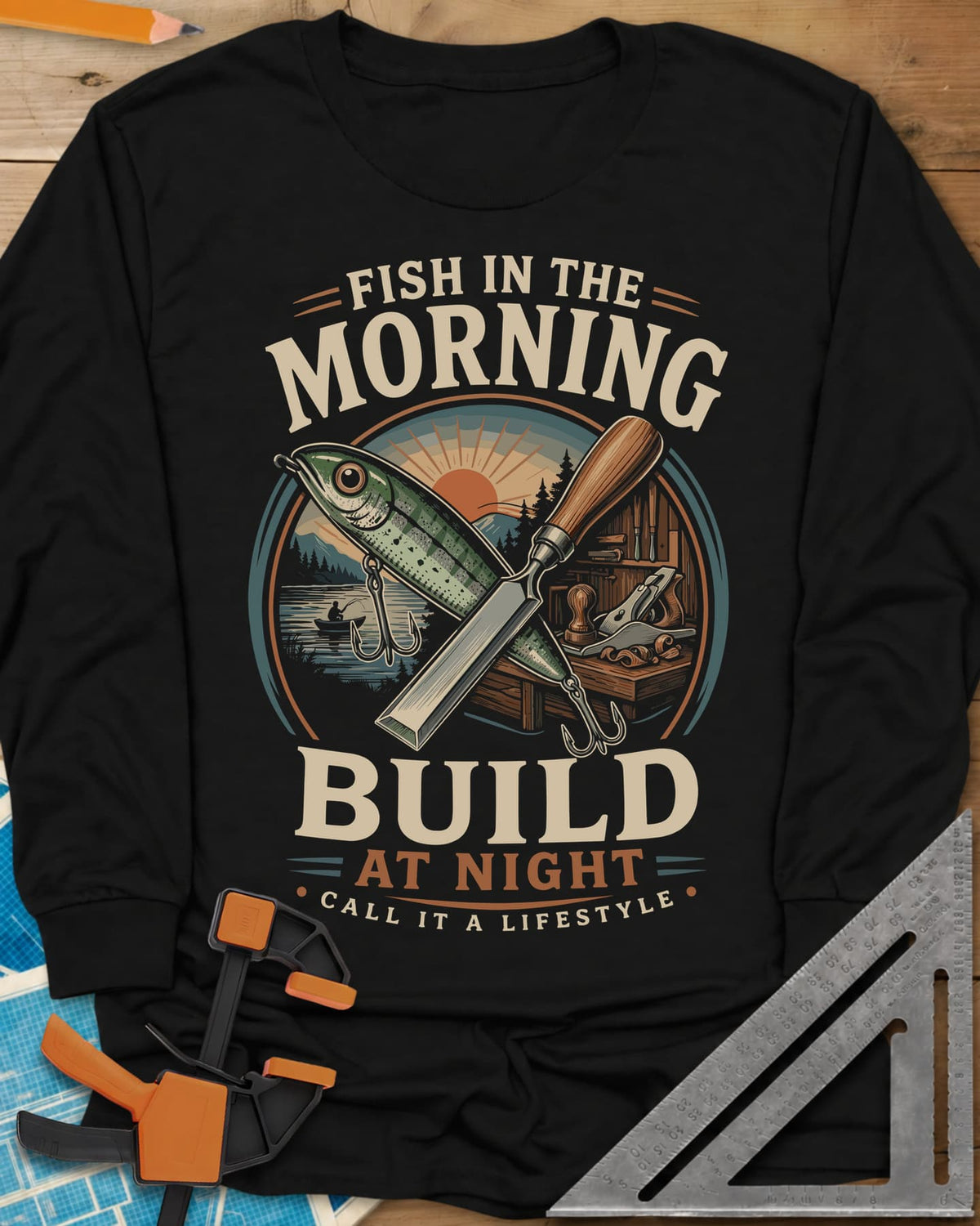 Fish In The Morning Build At Night long sleeve shirt in Black, a round badge with a fishing lure crossed over a chisel