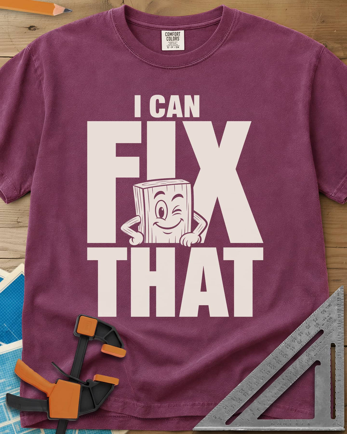 Fix That heavyweight tee in Berry, a winking cartoon wood block peeking from behind big letters
