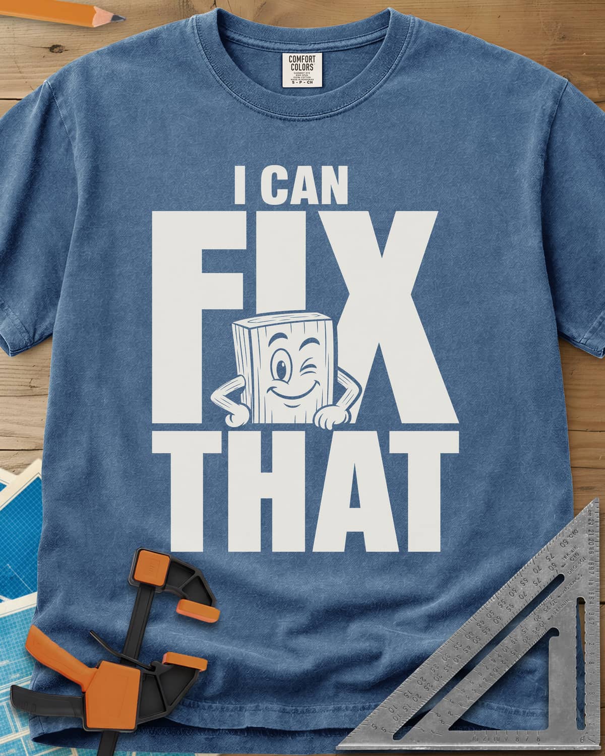 Fix That heavyweight tee in Blue Jean, a winking cartoon wood block peeking from behind big letters