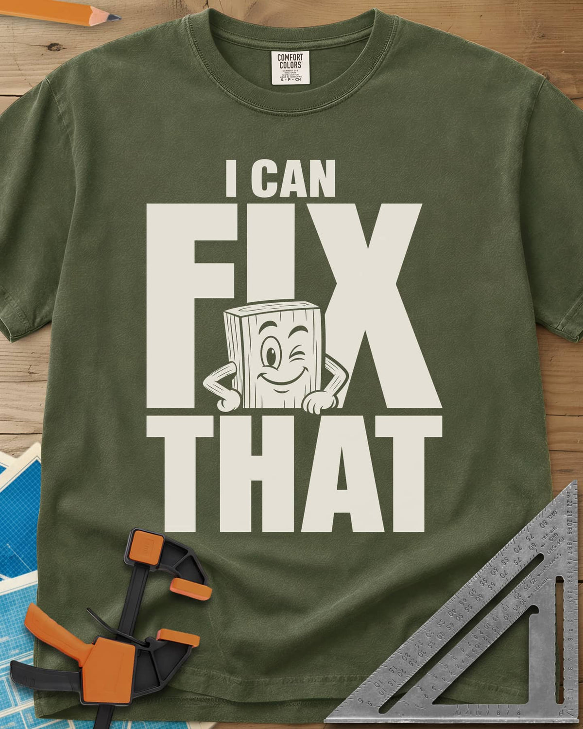 Fix That heavyweight tee in Hemp, a winking cartoon wood block peeking from behind big letters