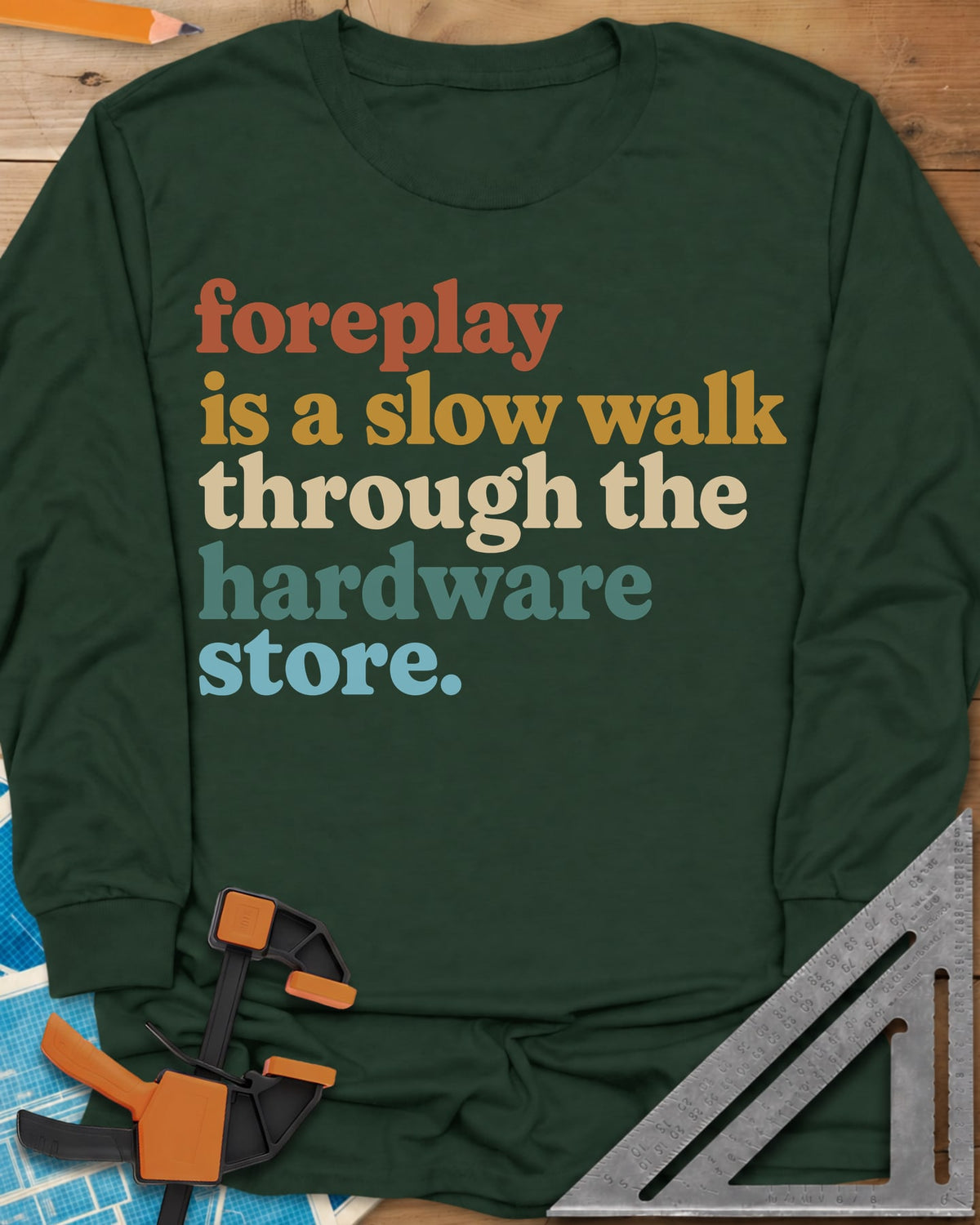 Foreplay Hardware Store long sleeve shirt in Forest Green, stacked lowercase lettering in rust, mustard, cream, teal and blue