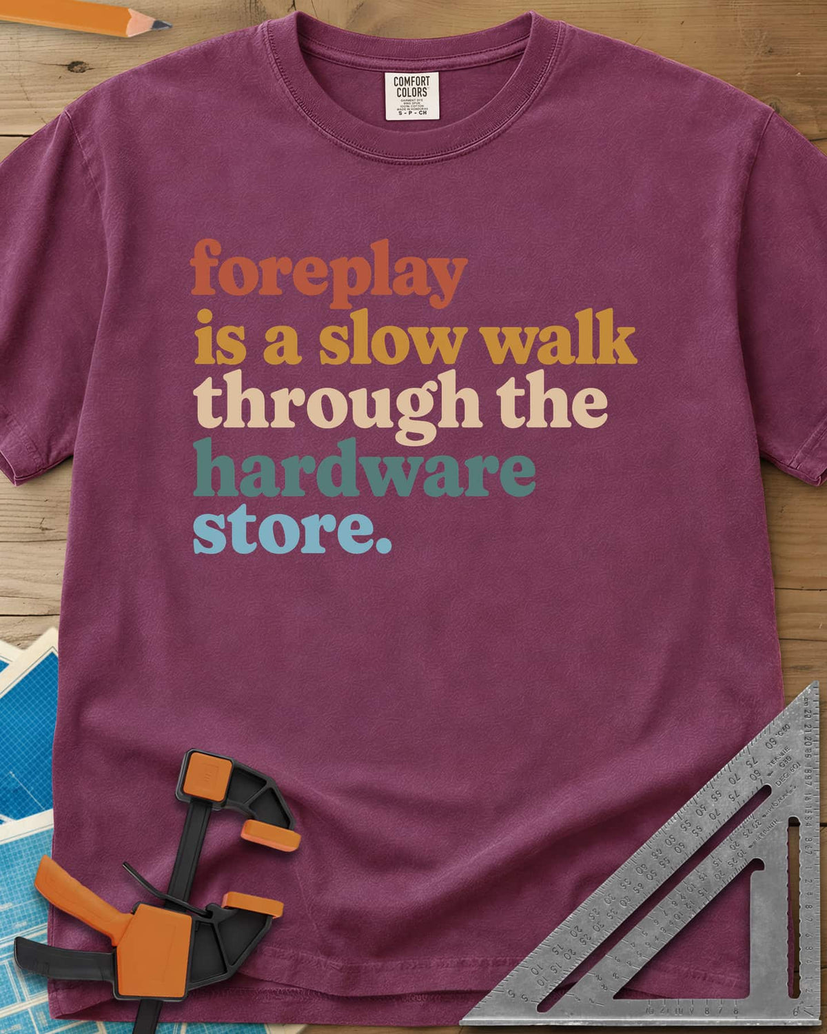 Foreplay Hardware Store heavyweight tee in Berry, stacked lowercase lettering in rust, mustard, cream, teal and blue