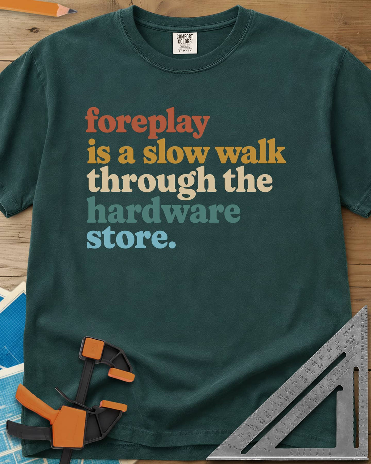 Foreplay Hardware Store heavyweight tee in Blue Spruce, stacked lowercase lettering in rust, mustard, cream, teal and blue