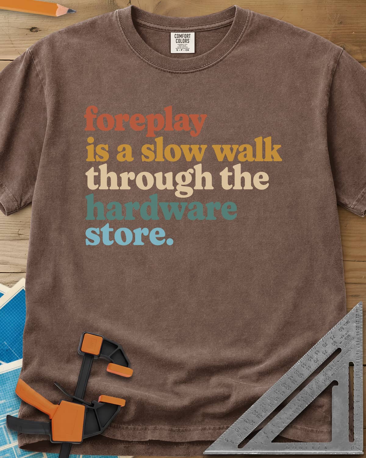 Foreplay Hardware Store heavyweight tee in Espresso, stacked lowercase lettering in rust, mustard, cream, teal and blue