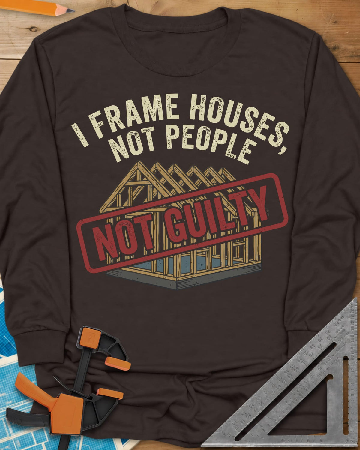 Frame Houses long sleeve shirt in Dark Chocolate, a wood-framed house with a red NOT GUILTY stamp